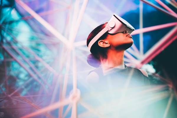 Pretty young African girl adjusting the VR headset on the modern background.